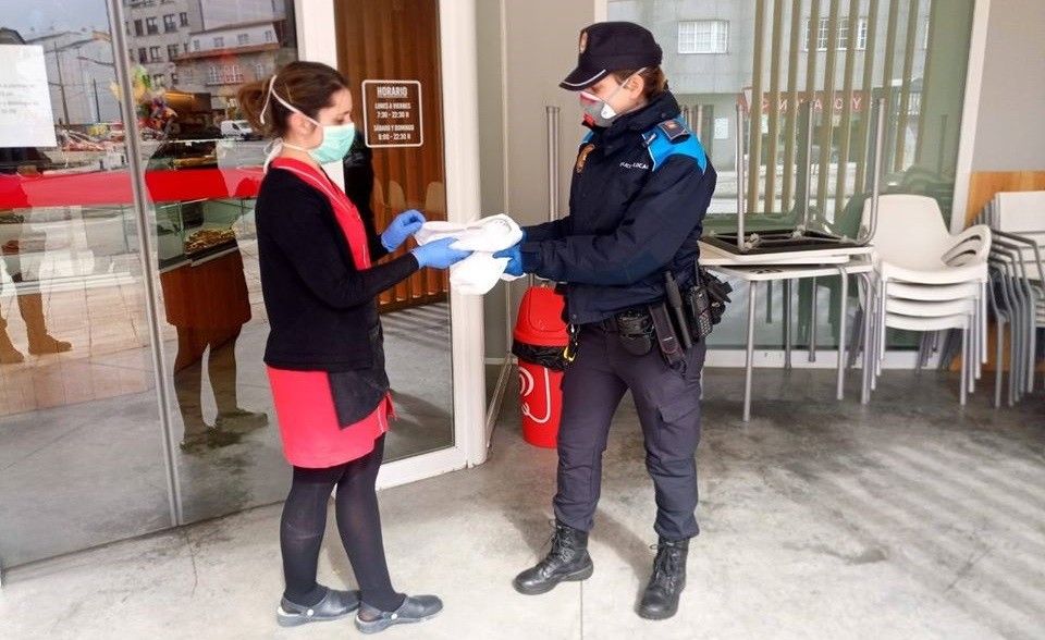 Axentes da Policía Local de Poio repartindo mascaras