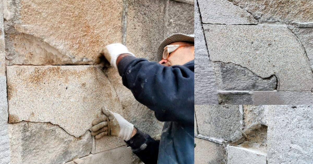 Un operario traballa na restauración do muro da igrexa onde figuraba o monumento falanxista