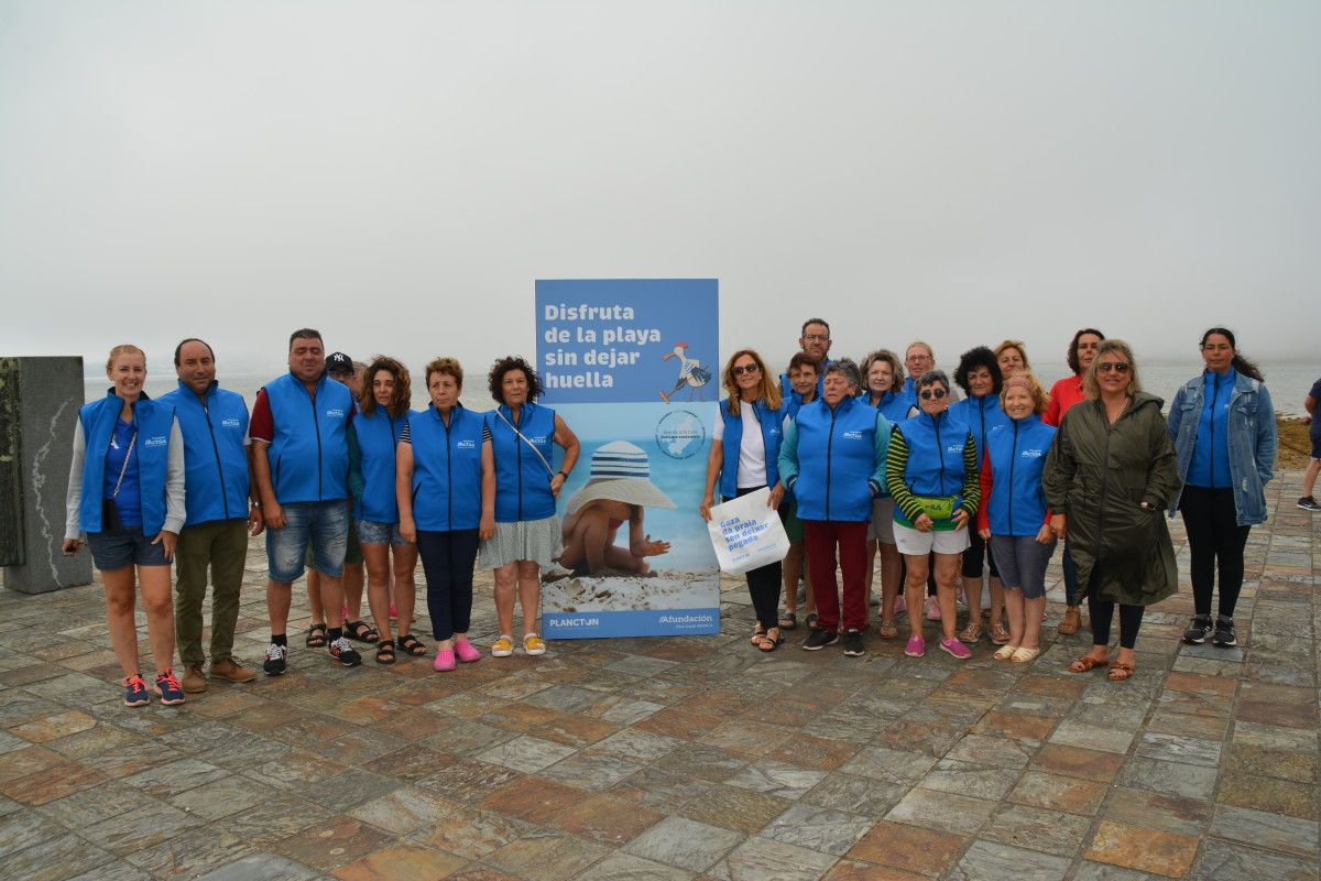As mariscadoras convidan os turistas a "gozar da praia sen deixar pegada"