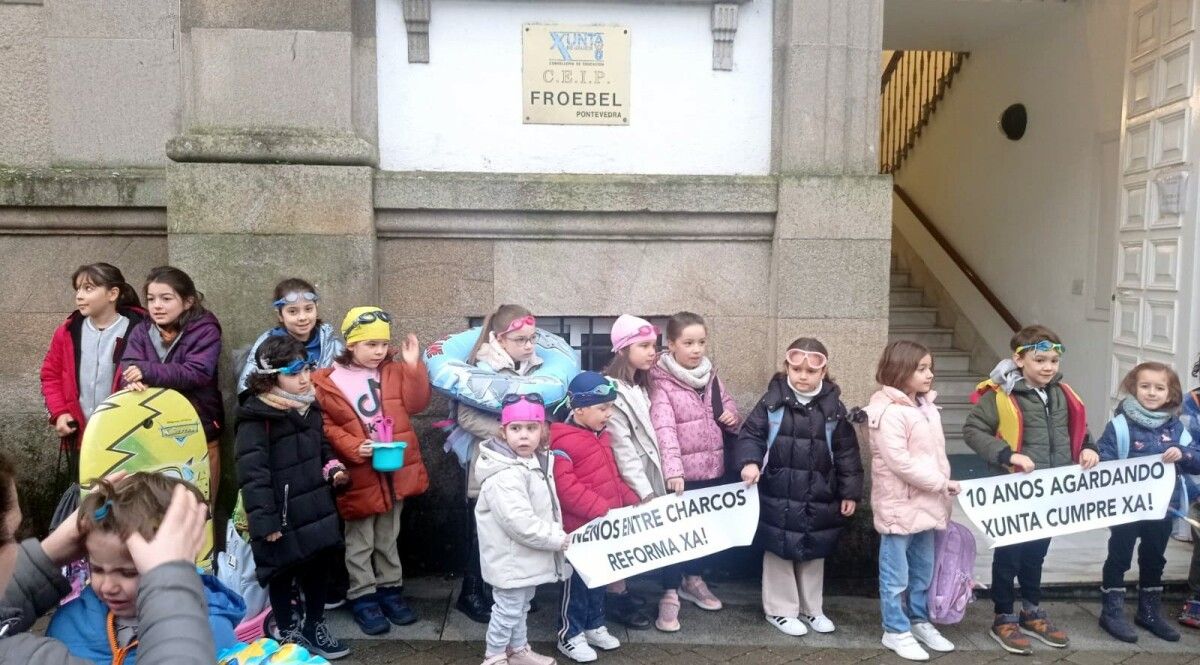 Escolares do CEIP Froebel con gafas acuáticas e flotadores para protestar polas pingueiras no centro educativo