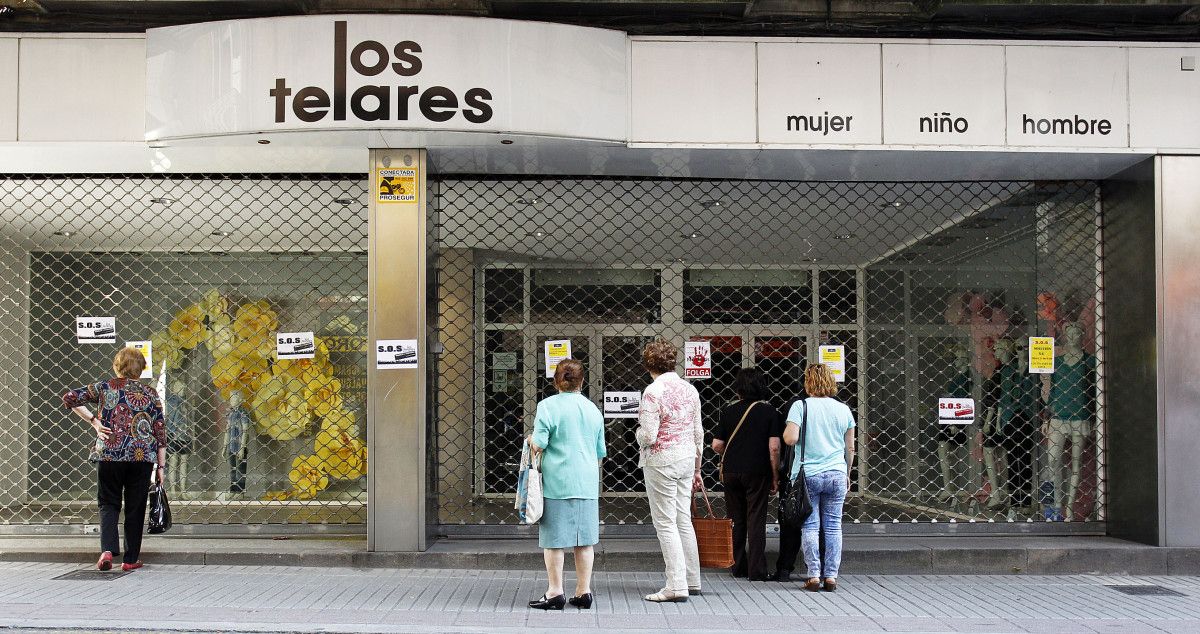 Clientes de Los Telares curiosean ante la tienda cerrada por huelga