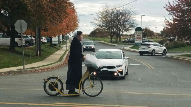 Unha rapaza móvese nunha antiga bicicleta sen pedais Unha rapaza móvese nunha antiga bicicleta sen pedais