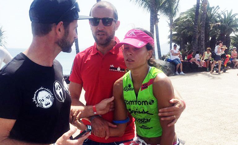 Saleta Castro, ayudada por su entrenador, en el momento de retirarse del Ironman de Lanzarote
